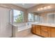 Bright bathroom featuring a shower, tub, and vanity with modern fixtures and a large window at 2792 S Ceylon St, Aurora, CO 80013