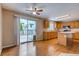 Open kitchen featuring hardwood floors, center island, and sliding glass doors leading to the backyard at 2792 S Ceylon St, Aurora, CO 80013
