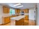 Well-lit kitchen with wooden cabinets, kitchen island, and modern appliances including stainless steel microwave at 2792 S Ceylon St, Aurora, CO 80013