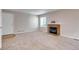 Comfortable living room featuring carpeted floors, fireplace, and large window with natural lighting at 2792 S Ceylon St, Aurora, CO 80013