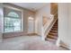Inviting living room with neutral-toned walls, large window, and a staircase leading to the upper level at 2792 S Ceylon St, Aurora, CO 80013