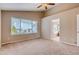Spacious main bedroom featuring carpeted floors, a large window, and access to the ensuite bathroom at 2792 S Ceylon St, Aurora, CO 80013