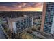 Stunning aerial view of the building with balconies and sunset; lush landscaping surrounds the property at 4800 E Hale Pkwy # 712N, Denver, CO 80220