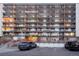 Multiple units share access to balconies, with parking spaces at the front and a wide entrance at 4800 E Hale Pkwy # 712N, Denver, CO 80220