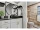 Modern bathroom featuring a vessel sink, decorative round mirror, and a walk-in shower at 4800 E Hale Pkwy # 712N, Denver, CO 80220