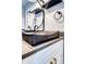 Modern bathroom featuring a unique dark vessel sink, contemporary hardware and a round mirror at 4800 E Hale Pkwy # 712N, Denver, CO 80220