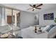Bright bedroom featuring a modern ceiling fan, an attached balcony, and a cozy lounge area at 4800 E Hale Pkwy # 712N, Denver, CO 80220