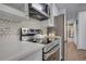 Modern kitchen showcasing stainless steel appliances, white cabinets, and quartz countertops, providing a clean and functional space at 4800 E Hale Pkwy # 712N, Denver, CO 80220