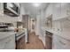 Bright kitchen featuring stainless steel appliances, white cabinetry, and modern hardware at 4800 E Hale Pkwy # 712N, Denver, CO 80220