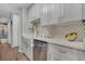 Stylish kitchen features white cabinets, quartz countertops, a farmhouse sink, and designer gold hardware at 4800 E Hale Pkwy # 712N, Denver, CO 80220