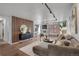 Modern living room features hardwood floors, accent wall, neutral color palette, and sliding doors to the balcony at 4800 E Hale Pkwy # 712N, Denver, CO 80220