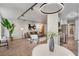 Open-concept living area boasts hardwood floors, a modern light fixture, and seamless flow to the kitchen at 4800 E Hale Pkwy # 712N, Denver, CO 80220