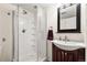 Updated bathroom featuring a glass-enclosed shower, modern vanity, and stylish fixtures at 12945 Columbine Cir, Thornton, CO 80241