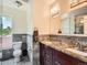 Bathroom featuring double sinks, granite countertops, tiled floors, and modern fixtures at 2775 California St, Denver, CO 80205