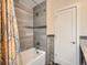 Bathroom with a tub, shower, grey tiled walls, and modern fixtures at 2775 California St, Denver, CO 80205