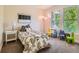 Bright bedroom with a twin bed, large windows, and colorful decor for  at 2775 California St, Denver, CO 80205