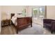 Sunlit bedroom with a sleigh bed, neutral carpet, and bright windows offering natural light at 2775 California St, Denver, CO 80205