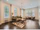 Bright living room featuring hardwood floors, area rug, neutral walls, and a decorative chandelier at 2775 California St, Denver, CO 80205