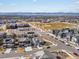 Expansive aerial view of the community with houses, a school, and parks against a scenic mountain backdrop at 1039 Highview Dr, Erie, CO 80516