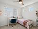 Cozy bedroom featuring a ceiling fan, a desk near a window, and a comfortable twin bed at 1039 Highview Dr, Erie, CO 80516