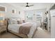 Light-filled bedroom with a plush bed, neutral tones, and a cozy reading nook at 1039 Highview Dr, Erie, CO 80516