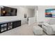Upstairs bonus room featuring modern console, a flat screen TV, and a relaxing armchair at 1039 Highview Dr, Erie, CO 80516