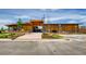 Modern clubhouse exterior featuring wood and stone finishes, surrounded by well-maintained landscaping at 1039 Highview Dr, Erie, CO 80516
