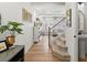 Inviting entryway featuring hardwood floors, a staircase, and views into the living room at 1039 Highview Dr, Erie, CO 80516