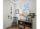 Bright entryway featuring hardwood floors, a small hall table with decor, and a white front door at 1039 Highview Dr, Erie, CO 80516