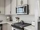 Modern kitchen with stainless steel appliances, sleek cabinetry, and bright backsplash at 1039 Highview Dr, Erie, CO 80516