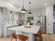 Bright kitchen features a large center island with bar seating and stainless steel appliances at 1039 Highview Dr, Erie, CO 80516