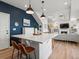 Bright and open kitchen island overlooks the living area with hardwood floors at 1039 Highview Dr, Erie, CO 80516