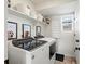 Well-organized laundry room with front load washer and dryer, shelving, and natural light at 1039 Highview Dr, Erie, CO 80516