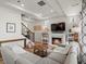 Bright living room showcasing a fireplace, built-in bookshelves, and a comfortable sectional sofa at 1039 Highview Dr, Erie, CO 80516