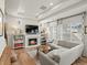 Cozy living room with a fireplace, built-in bookshelves, and a comfortable gray sectional sofa at 1039 Highview Dr, Erie, CO 80516