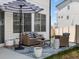 Outdoor patio showcasing a cozy seating area with a striped umbrella, perfect for relaxing and entertaining at 1039 Highview Dr, Erie, CO 80516