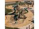 Aerial view of a modern playground with climbing structures, slides, and wood chip ground cover at 1039 Highview Dr, Erie, CO 80516