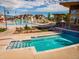 Community pool area featuring a splash zone, lap pool, and lounge chairs, surrounded by landscaping at 1039 Highview Dr, Erie, CO 80516