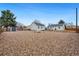 Expansive backyard featuring gravel, a fire pit, and two detached structures at 4455 Brentwood St, Wheat Ridge, CO 80033