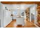 White kitchen featuring a kitchen island with wood countertop, wooden floors, and ample storage at 4455 Brentwood St, Wheat Ridge, CO 80033