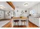 Bright, white kitchen featuring a kitchen island with bar stools and open floor plan at 4455 Brentwood St, Wheat Ridge, CO 80033