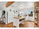 Bright kitchen with a white island, wood countertop, and open shelving at 4455 Brentwood St, Wheat Ridge, CO 80033