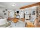 Inviting, open-concept living room featuring hardwood floors and views to the kitchen at 4455 Brentwood St, Wheat Ridge, CO 80033