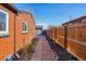 Brick home with a pathway, gravel landscaping, and a wooden fence at 3324 N Glencoe St, Denver, CO 80207