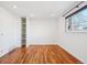 Simple bedroom with hardwood floors and built-in shelves at 3324 N Glencoe St, Denver, CO 80207