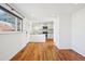 Open concept dining area with kitchen and hardwood floors at 3324 N Glencoe St, Denver, CO 80207