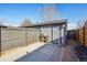 Detached garage with a gray door and a small concrete patio at 3324 N Glencoe St, Denver, CO 80207