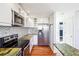 Modern kitchen with stainless steel appliances and granite countertops at 3324 N Glencoe St, Denver, CO 80207