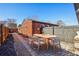 Outdoor patio with a wood table and chairs, perfect for dining al fresco at 3324 N Glencoe St, Denver, CO 80207