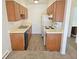 Simple kitchen with wood cabinets and modern flooring at 14751 E Tennessee Dr # 226, Aurora, CO 80012